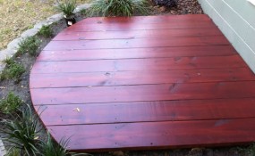 A small deck within a planting bed.
